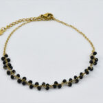 Chique gouden enkelband met zwarte kralen