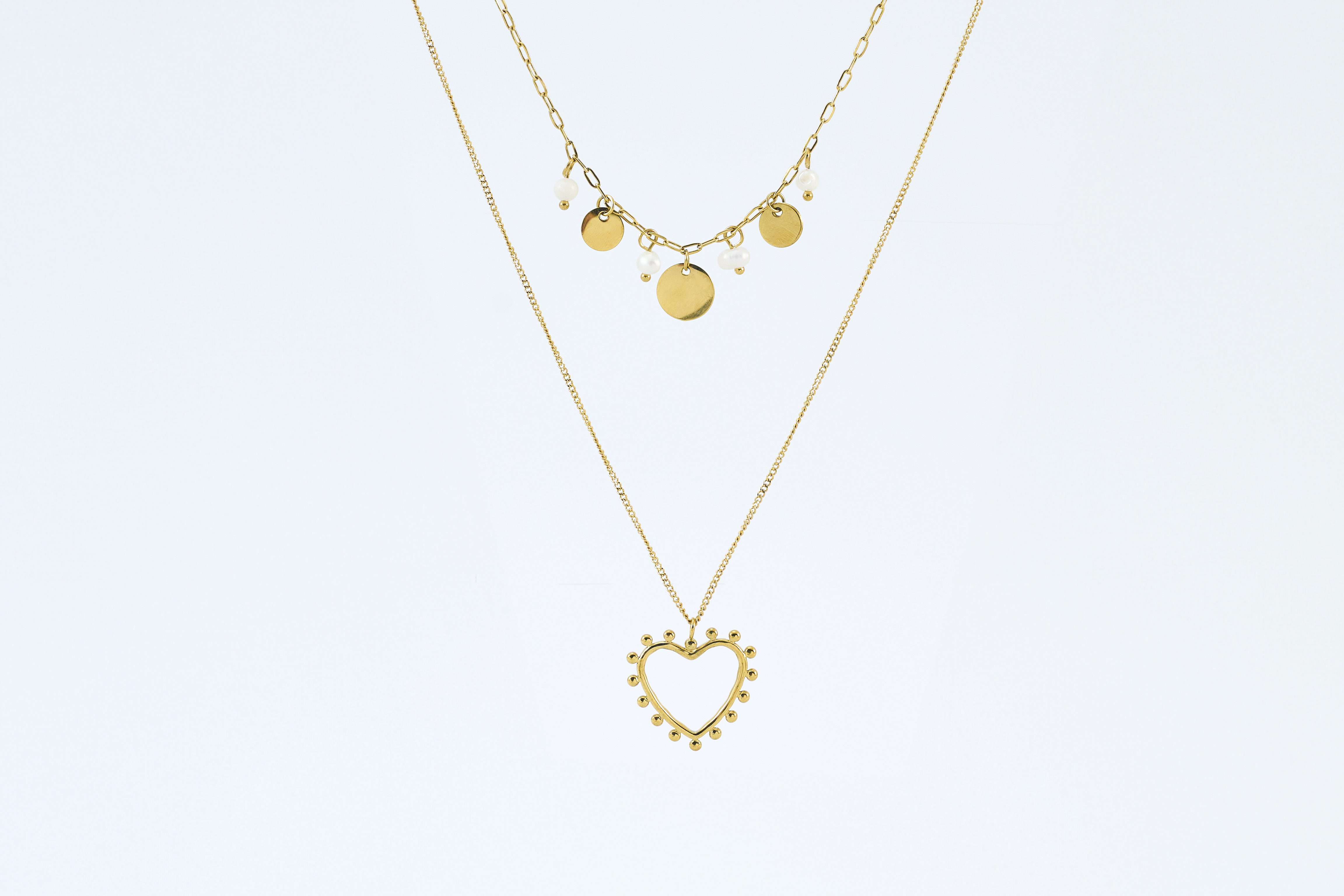 Dubbele ketting met gouden hartjes en open hart