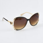 Golden Grace – Bruine oversized zonnebril met gouden details