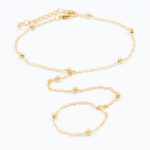 Gouden armband met klavertjes en kraaltjes