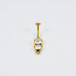 Gouden buikpiercing met schedeldesign